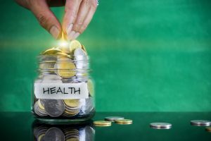 Preparation for future and financial concept. Coins in glass jar with HEALTH label. Malaysia coins.